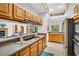 Open kitchen with stainless steel appliances and tile flooring at 10 Greenhaven Cir, Oldsmar, FL 34677