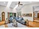 Open living room with a vaulted ceiling and views into the kitchen and backyard at 10 Greenhaven Cir, Oldsmar, FL 34677