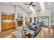 Bright living room with skylights, brick fireplace, and sliding door access to patio at 10 Greenhaven Cir, Oldsmar, FL 34677