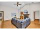Spacious living room with hardwood floors, brick fireplace, and a ceiling fan at 10 Greenhaven Cir, Oldsmar, FL 34677
