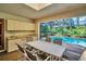Screened patio with dining area featuring a partial kitchen and access to the pool at 10 Greenhaven Cir, Oldsmar, FL 34677