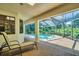The patio offers a relaxing outdoor space with views of the pool and lush greenery at 10 Greenhaven Cir, Oldsmar, FL 34677
