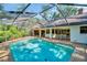 Screened-in pool features clear blue water and offers an idyllic outdoor space for relaxation and entertainment at 10 Greenhaven Cir, Oldsmar, FL 34677