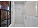A fully tiled shower stall offers a clean, modern aesthetic, enhanced by a decorative privacy window at 10 Greenhaven Cir, Oldsmar, FL 34677