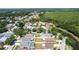 An aerial view showing a quiet residential area, mature trees, homes with pools, and nearby pond at 10918 Lake Andover Blvd, Tampa, FL 33624