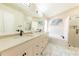 Stylish bathroom features double sinks, marble countertops, a soaking tub, and glass shower at 10918 Lake Andover Blvd, Tampa, FL 33624