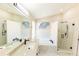 Elegant bathroom featuring double sinks, marble countertops, a soaking tub, and glass shower at 10918 Lake Andover Blvd, Tampa, FL 33624