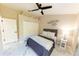 Stylish bedroom featuring a ceiling fan, closet, and elegant décor, bathed in natural light at 10918 Lake Andover Blvd, Tampa, FL 33624