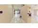 Bright hallway leads to a spacious living area and a modern kitchen at 10918 Lake Andover Blvd, Tampa, FL 33624