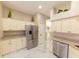 Spacious kitchen featuring stainless steel refrigerator and white marble countertops at 10918 Lake Andover Blvd, Tampa, FL 33624