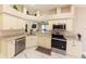 Well-lit kitchen featuring stainless steel appliances, light countertops, and modern cabinets at 10918 Lake Andover Blvd, Tampa, FL 33624