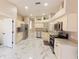 Bright kitchen featuring stainless steel appliances, marble flooring, and white cabinets at 10918 Lake Andover Blvd, Tampa, FL 33624