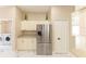 Bright kitchen with stainless steel fridge, white cabinets and marbled countertops at 10918 Lake Andover Blvd, Tampa, FL 33624