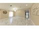 Open-concept living room with marble floors and elegant chandelier at 10918 Lake Andover Blvd, Tampa, FL 33624