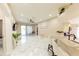 Open living area with bar seating, modern flooring, and access to the screened patio at 10918 Lake Andover Blvd, Tampa, FL 33624