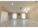 Bright living room featuring marble floors, large windows, and a contemporary chandelier at 10918 Lake Andover Blvd, Tampa, FL 33624