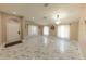 Spacious living room with marble floors, lots of natural light, and elegant light fixture at 10918 Lake Andover Blvd, Tampa, FL 33624