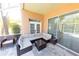 Relaxing screened-in patio with stylish seating, perfect for outdoor enjoyment at 10918 Lake Andover Blvd, Tampa, FL 33624