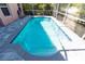 Screened-in pool has a stone trim around the outside, with a clear blue interior, and an adjacent exterior wall at 10918 Lake Andover Blvd, Tampa, FL 33624
