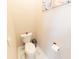 Cozy powder room features tile flooring, a toilet, and modern paper towel dispenser at 10918 Lake Andover Blvd, Tampa, FL 33624