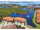 Waterfront townhome featuring private garage and community water feature with fountains, surrounded by mature landscaping at 11 Franklin S Ct # C, St Petersburg, FL 33711