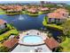 Resort-style community pool with spa, lounge chairs, and beautiful landscaping with water views at 11 Franklin S Ct # C, St Petersburg, FL 33711