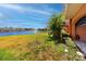 Waterfront backyard with lush grass, fountain view, and access to the patio at 11 Franklin S Ct # C, St Petersburg, FL 33711