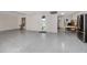 Finished basement with speckled epoxy flooring, work area, and outside access at 11 Franklin S Ct # C, St Petersburg, FL 33711