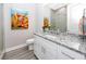 Bathroom featuring white cabinetry, granite counters, a decorative painting, and a glass shower at 11 Franklin S Ct # C, St Petersburg, FL 33711
