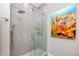 Modern bathroom with a glass-enclosed shower featuring a rain shower head and decorative artwork at 11 Franklin S Ct # C, St Petersburg, FL 33711