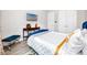 Bedroom with an accent table, a TV, and a blue headboard bed dressed in white linens at 11 Franklin S Ct # C, St Petersburg, FL 33711