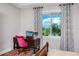Bright bedroom with water view from the window, a desk, and a pink chair at 11 Franklin S Ct # C, St Petersburg, FL 33711