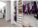 Bright, organized closet with shelves, drawers, clothing rods, and a cozy white furry stool at 11 Franklin S Ct # C, St Petersburg, FL 33711