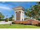 Marina Bay community entrance with stone accents, lush landscaping, and the American flag at 11 Franklin S Ct # C, St Petersburg, FL 33711