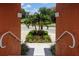 The front entrance has palm trees, well kept landscape, and an inviting concrete walkway at 11 Franklin S Ct # C, St Petersburg, FL 33711