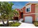 Beautiful townhome showcasing a garage, landscaped front yard, and welcoming front entrance at 11 Franklin S Ct # C, St Petersburg, FL 33711