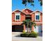 Attractive exterior view showcasing an attached garage, manicured landscaping, and charming architectural details at 11 Franklin S Ct # C, St Petersburg, FL 33711