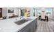 A large kitchen island offers seating and food prep space, along with sleek countertops and modern design at 11 Franklin S Ct # C, St Petersburg, FL 33711