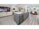 Open concept kitchen with a large center island featuring a stainless steel sink and modern appliances at 11 Franklin S Ct # C, St Petersburg, FL 33711