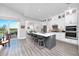 Kitchen with a gray island, white cabinetry, and access to an outdoor balcony at 11 Franklin S Ct # C, St Petersburg, FL 33711