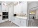 Bright kitchen with white cabinets, stainless steel appliances, and marble backsplash at 11 Franklin S Ct # C, St Petersburg, FL 33711