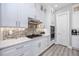 Contemporary kitchen features marble countertops, tile backsplash, and stainless steel appliances at 11 Franklin S Ct # C, St Petersburg, FL 33711