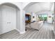 Bright living room with wood floors, large white sofa, and sliding glass doors to the outside at 11 Franklin S Ct # C, St Petersburg, FL 33711