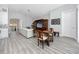 Open concept living room featuring a white sofa, game table, and an entertainment center at 11 Franklin S Ct # C, St Petersburg, FL 33711