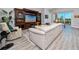 Living room featuring a white sofa, patterned armchair, and a large decorative entertainment center at 11 Franklin S Ct # C, St Petersburg, FL 33711
