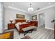 Well-lit main bedroom with a decorative chandelier, wooden furniture, and a patterned bench at 11 Franklin S Ct # C, St Petersburg, FL 33711