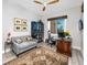 Bright office with a decorative ceiling fan, work desk, and sofa seating at 11 Franklin S Ct # C, St Petersburg, FL 33711