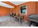 Cozy covered patio with tile flooring, outdoor grill, and dining area at 11 Franklin S Ct # C, St Petersburg, FL 33711
