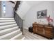 Elegant staircase with painted steps, wood accents, and a stylish console table and art at 11 Franklin S Ct # C, St Petersburg, FL 33711