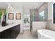 Modern bathroom features a soaking tub, glass shower, dual vanity, and contemporary design at 114 W Plymouth St, Tampa, FL 33603